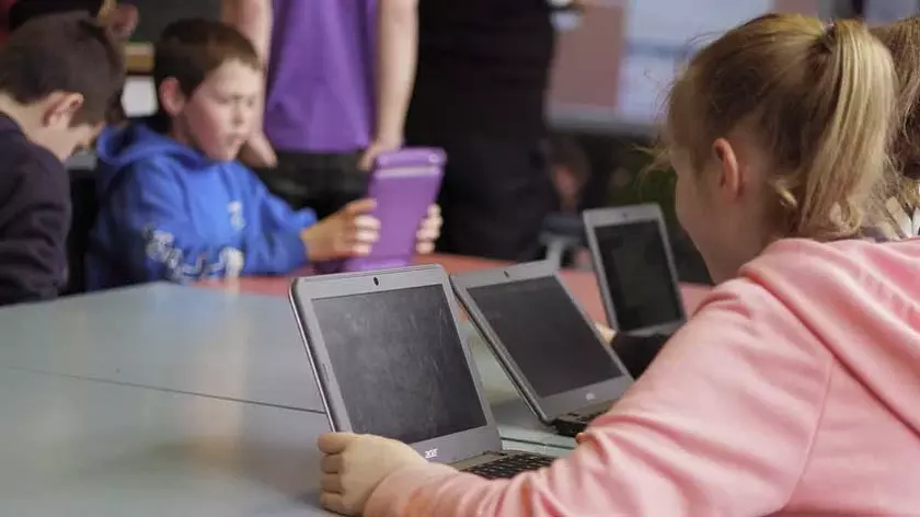 primary school students on laptops